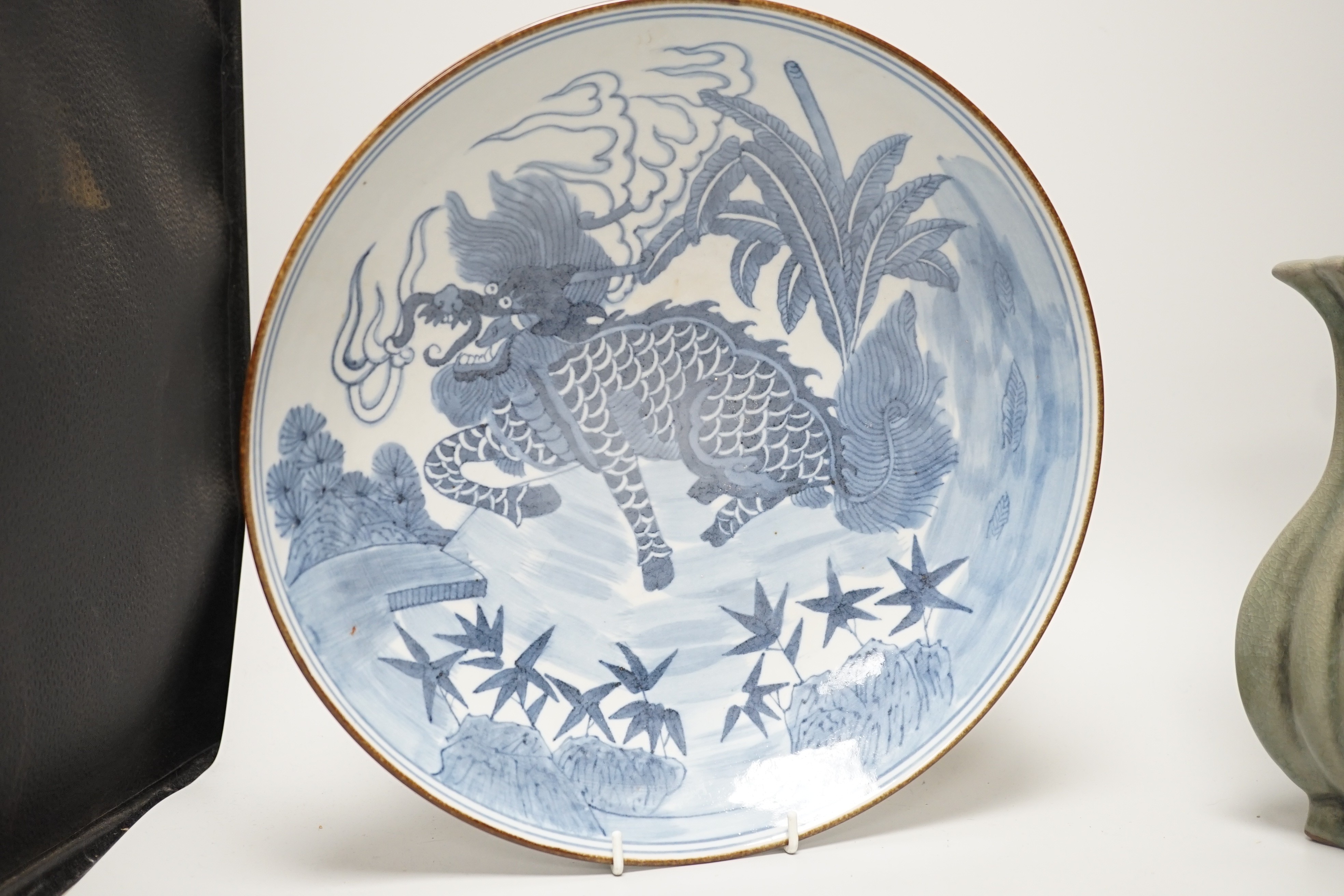 A Chinese blue and white ‘qilin’ dish, an octagonal bowl and a Korean celadon vase (3) largest 33cm diameter